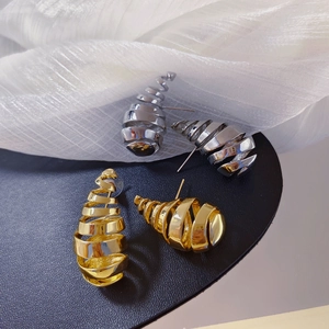 Polished gold and silver spiral hollow teardrop stud earrings in a minimalist design
