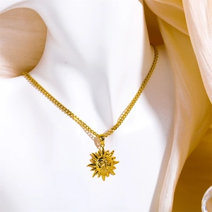 Vintage gold sun face pendant necklace with Cuban chain displayed on a white bust