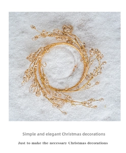 Detailed view of a gold wire Christmas wreath with clear beads and festive glitter