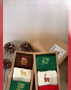 Three pairs of festive Christmas socks with gingerbread man and reindeer embroidery