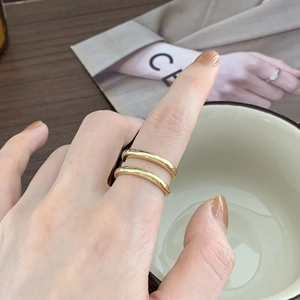 Minimalist double-layered gold ring for women shown in a stylish lifestyle setting