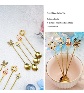 Detailed view of Christmas dessert spoons with Santa and reindeer enamel charms