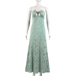 Detail of mint green lace dress featuring hollow-out chest design with metal ring decoration