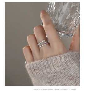 Close-up of a s925 silver double-layered ring with zircon stars on a finger