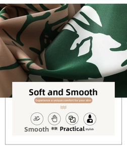 Detailed close-up of silky satin fabric with green leaf patterns and soft drape texture