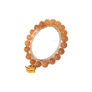 Natural sunstone beaded bracelet with golden Ruyi cloud charm for women on a display stand