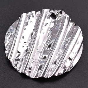 Detailed view of round 304 stainless steel pendant with water ripple texture and glossy finish