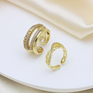 Adjustable gold plated ring set featuring a pearl ball and chain design on silk fabric