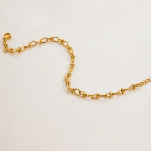 Detailed macro view of the elegant golden stainless steel chain link bracelet curve