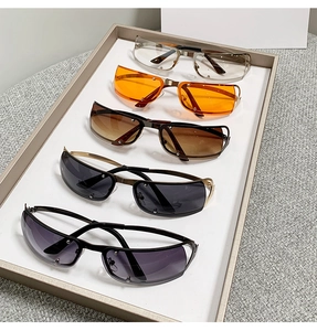 Macro view of retro steampunk oval sunglasses in various colors on a beige tray