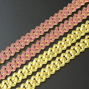 Hip hop style gold Cuban chains with pink rhinestones displayed on a black background
