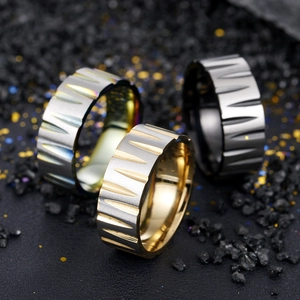 Industrial brushed stainless steel rings in gold, silver and black with sawtooth texture