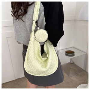 Detail of light yellow seersucker crossbody bag with a round FASHION coin purse accessory