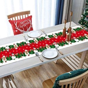 Close-up of Christmas table runner with snowman, trees, and snowflake patterns on wood