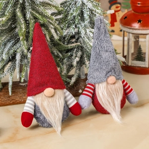 Christmas faceless gnome dolls in red and grey set against a cozy holiday scene