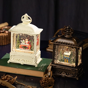 Vintage Christmas lantern music box with snow scene and LED lights in bronze and white