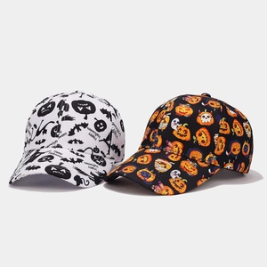 Close-up of black and white baseball caps with Happy Halloween print and festive patterns