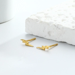 Minimalist S925 sterling silver gold lightning bolt stud earrings on white stone
