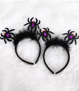 Detail of Halloween spider headbands with black feathers and purple gemstone accents