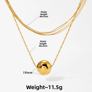 Detailed view of layered gold ball necklace with 40+5cm and 46+5cm chain lengths