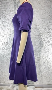 Detail view of purple square neck A-line dress featuring high waist and short sleeves