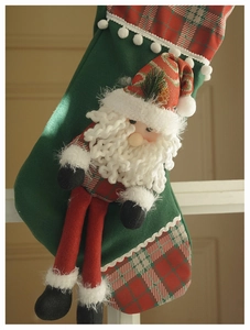 Detail of green felt Christmas stocking with 3D Santa Claus and white pom-pom trim