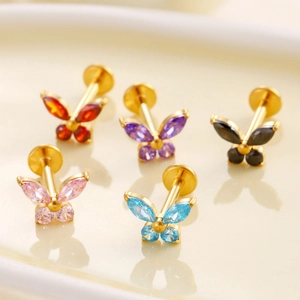 Titanium butterfly labret studs with colorful marquise zircons on a tray