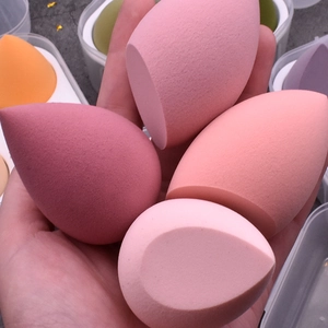 Set of multi-colored teardrop makeup sponges in various shades of pink and orange