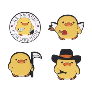 Set of four cute yellow duck enamel pins featuring grim reaper and angel designs