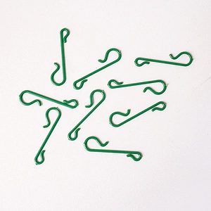 Close-up of green S-shaped hooks for Christmas ornaments and tree decorations