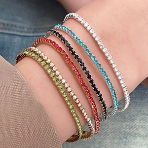 Macro shot of colorful cubic zirconia tennis bracelets stacked on a female wrist