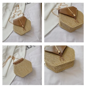 Detail of woven straw shoulder bag with leather flap and metallic tassel charm