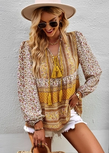 Detail of Bohemian V-neck blouse featuring paisley floral print and yellow tassel ties