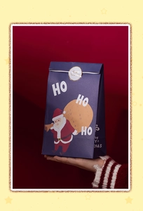 Detailed view of Christmas Santa gift bag with gold seal sticker and blue paper finish
