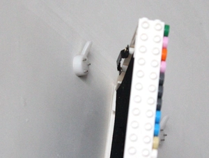 Side view detail of a white building block photo frame with seamless wall hanging hook