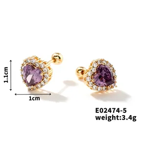 Macro detail of heart-shaped purple zircon earrings with gold screw-back butterfly
