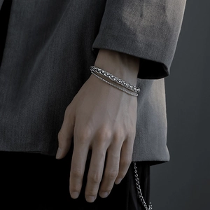 Men's silver titanium steel braided and bead chain bracelets set on a wrist