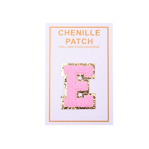 Detail of pink chenille letter E patch with gold glitter edge on display card