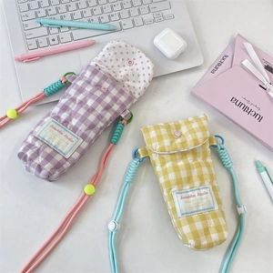 Detailed quilted texture and contrast braided straps of soft padded camera and phone bags