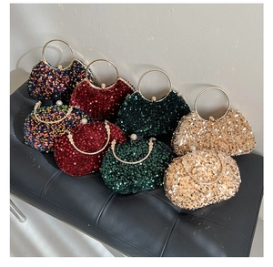 Detail of evening clutch bags with high-density sequins and rhinestone-studded gold handles