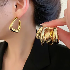 Chic gold geometric stud earrings with polished texture and twisted metal design for women
