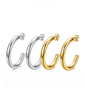 Detailed view of C-shaped hoop earrings in polished gold and silver stainless steel
