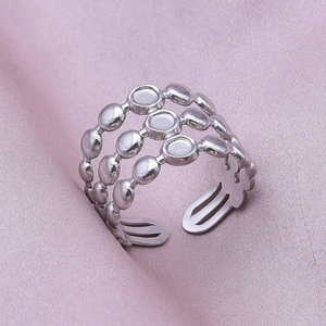 Detailed macro view of triple-layered silver metal ring with an adjustable open band design