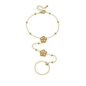 Gold eight-pointed star finger bracelet with white gemstone on white background