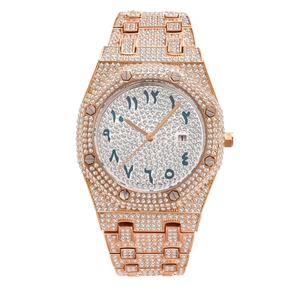 Detail of rose gold iced-out watch with Arabic numerals and luminous crystal bezel