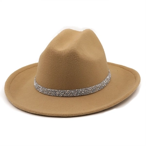 Close-up of camel wool fedora hat featuring a sparkling rhinestone chain accessory