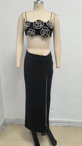Detail of black crop top featuring sparkling silver rhinestone floral rose embellishment