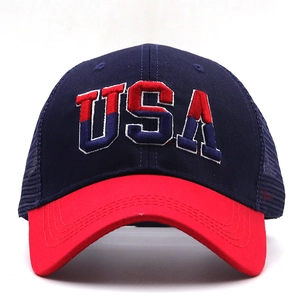 Detailed view of the 3D embroidered USA logo on a blue and red cotton mesh baseball cap