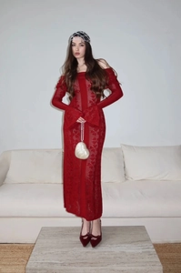 Detail of red hollow knit dress featuring an off-shoulder neckline and bell sleeves