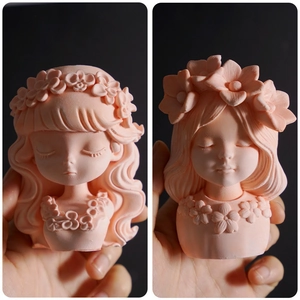 Detail view of two pink flower girl resin molds for succulent pots and candles